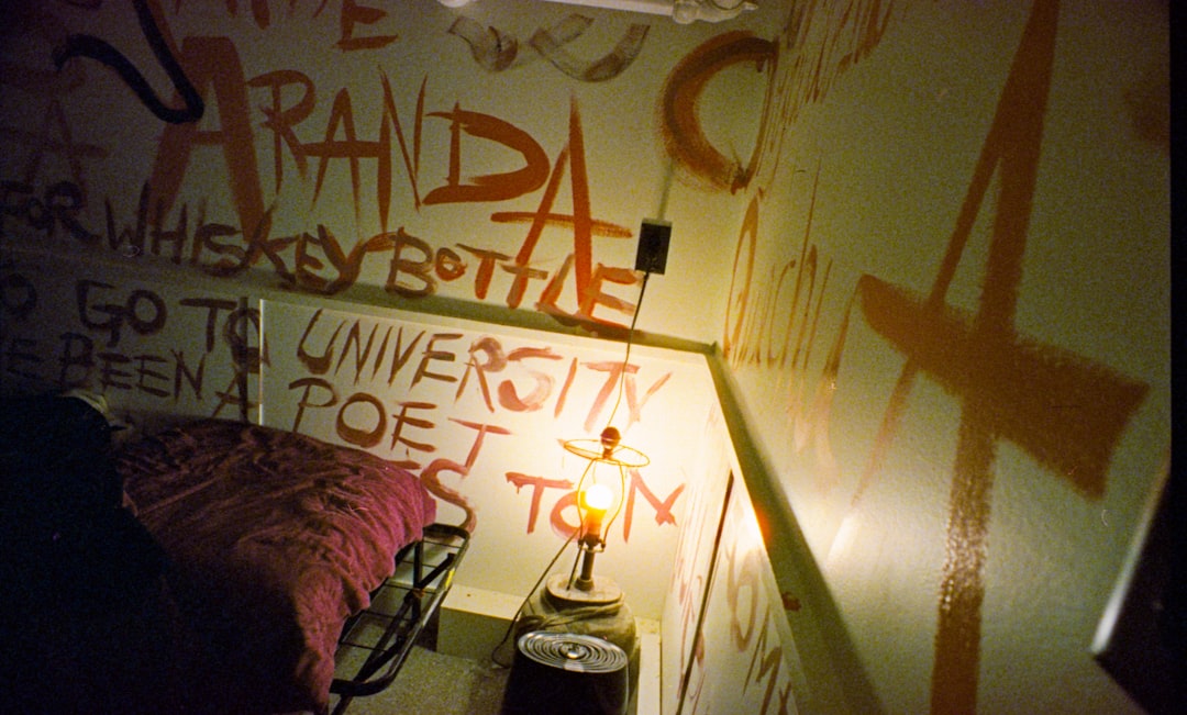 Wall covered in orange graffiti and writing.