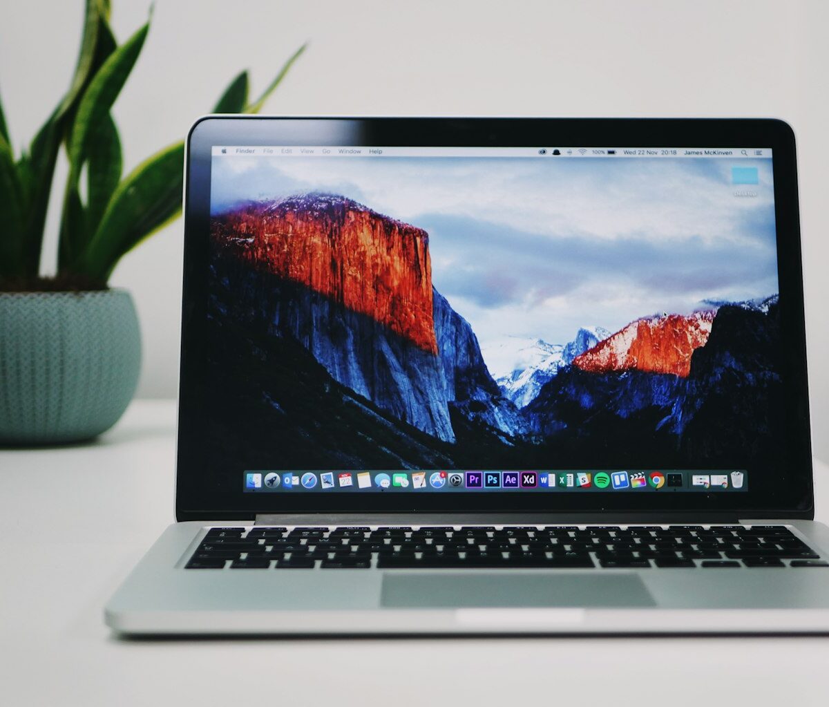 Iemand bekijkt een foto op een laptopscherm van dichtbij