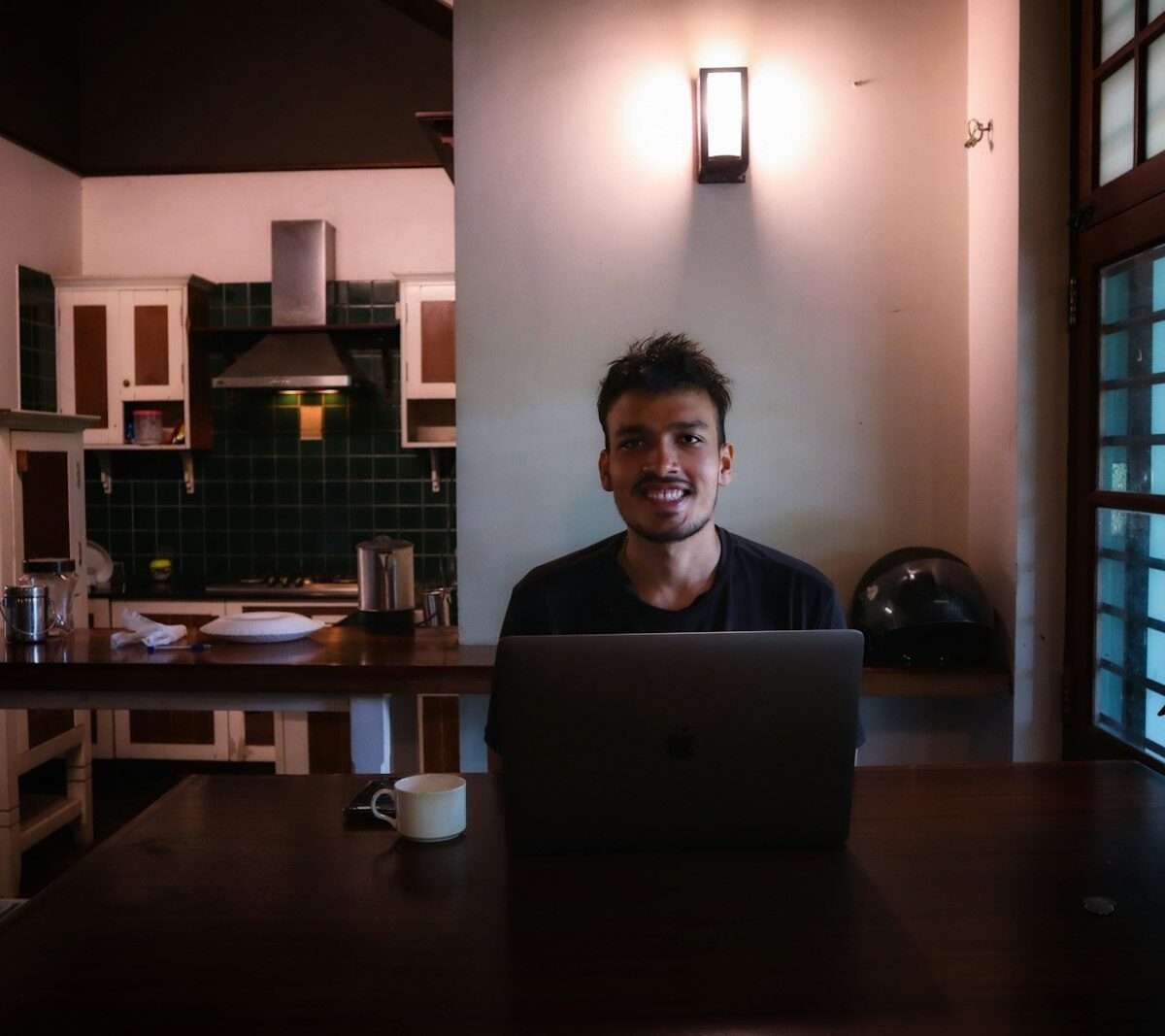 Jonge zelfstandige werkt aan een laptop aan een keukentafel